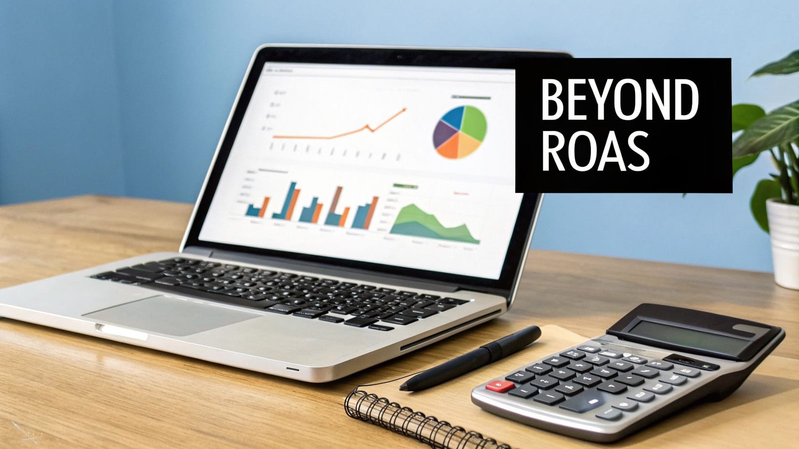 Laptop displaying analytics graphs, calculator, and notebook on a wooden desk, with 'BEYOND ROAS' text.